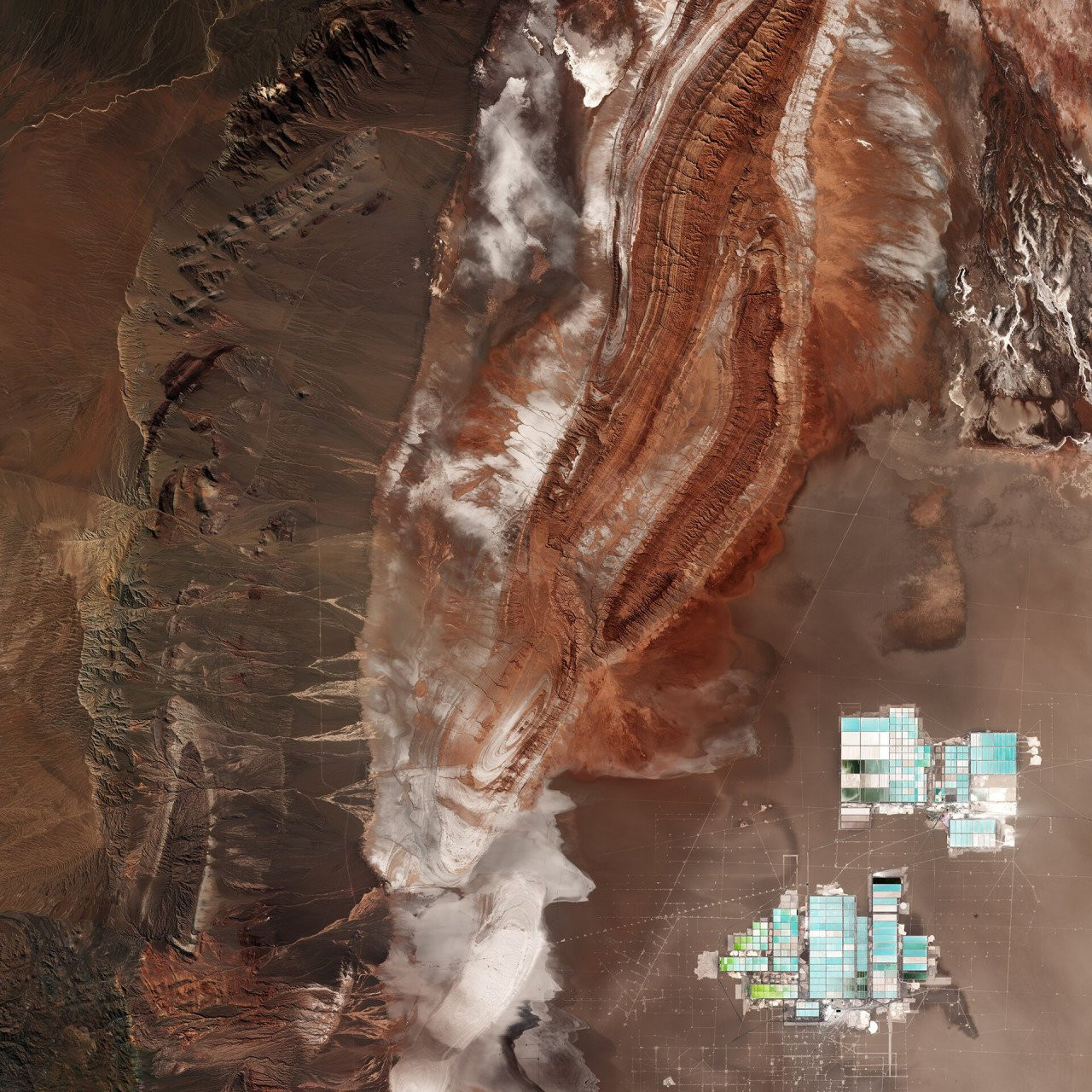 Salar de Atacama [geometric shapes at the bottom right] – Chile’s largest salt flat. At about 3000 sq km, it is the world’s third-largest salt flat as well as one of the largest active sources of lithium.
